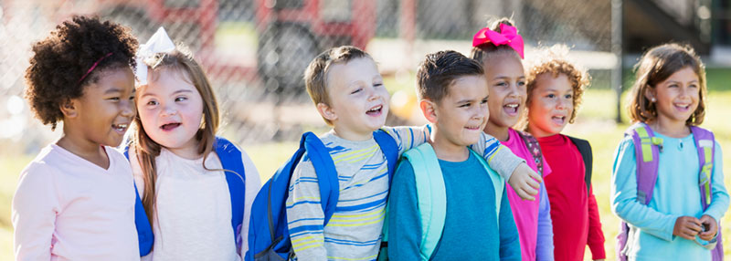 Young school students standing together outside